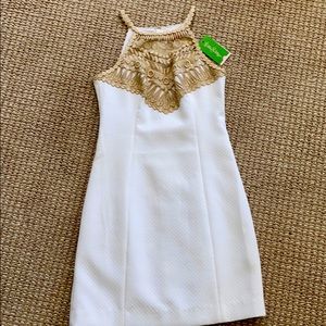 never worn. Light creamy color.  Gold trim